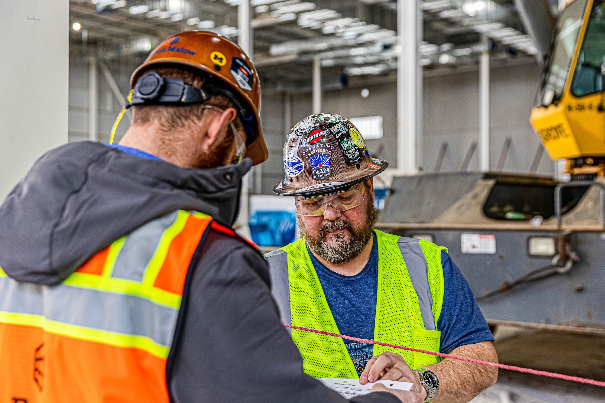 Construction Safety Manager Steve Sisler talking with another construction worker